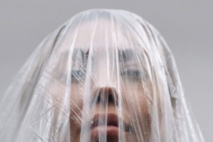 unrecognizable woman covered with plastic bag
