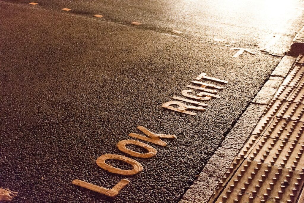 a close up of a street sign on the ground